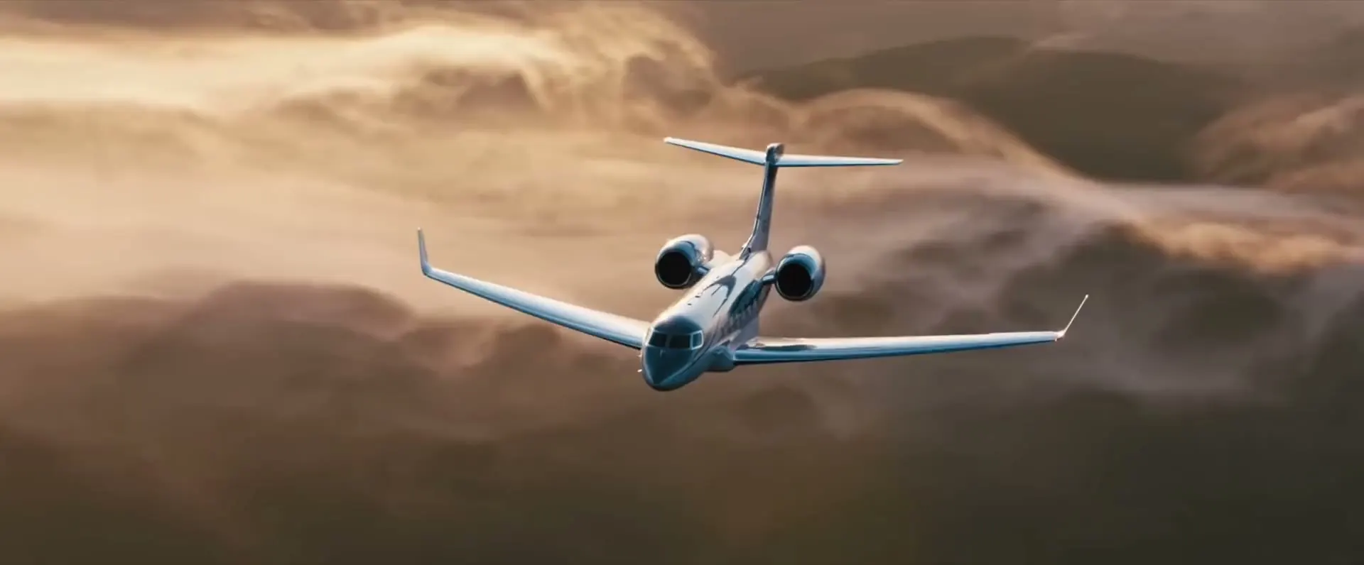 A Gulfstream jet flying above the clouds at golden hour.